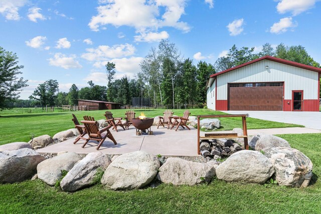 view of patio featuring an outbuilding and a garage