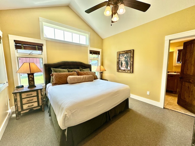 carpeted bedroom with lofted ceiling, ensuite bathroom, and ceiling fan