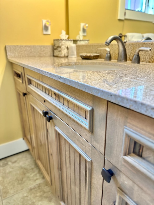 room details with vanity and tile patterned flooring