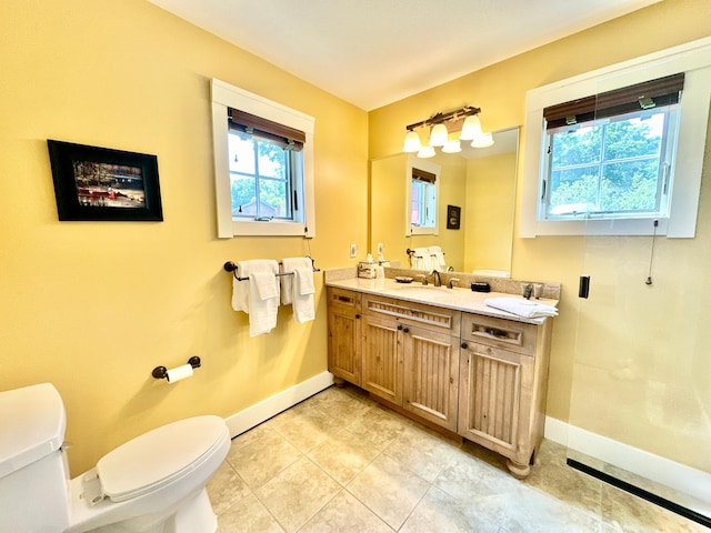 bathroom featuring toilet, baseboards, tile patterned floors, and vanity