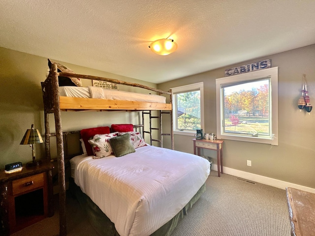 bedroom featuring carpet and a textured ceiling