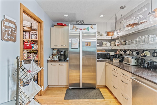 kitchen featuring open shelves, recessed lighting, hanging light fixtures, appliances with stainless steel finishes, and light wood-style floors