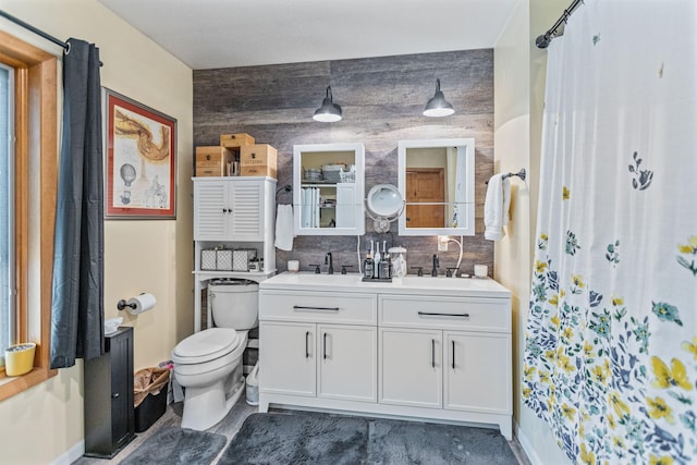 full bathroom featuring double vanity, tasteful backsplash, a sink, and toilet