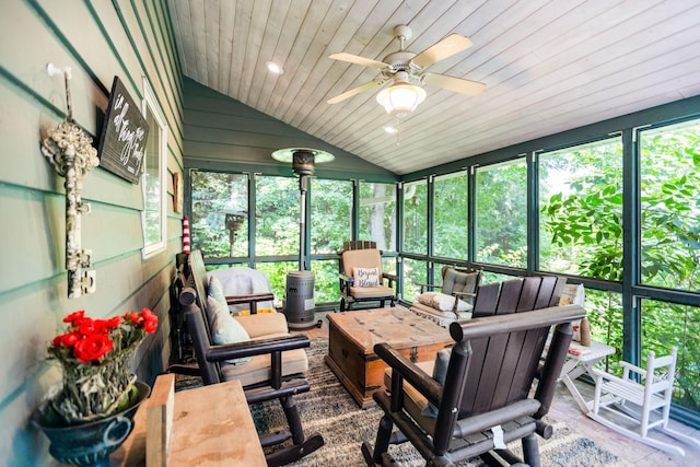 sunroom featuring lofted ceiling, ceiling fan, and wood ceiling