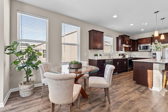 dining area with recessed lighting, baseboards, and wood finished floors