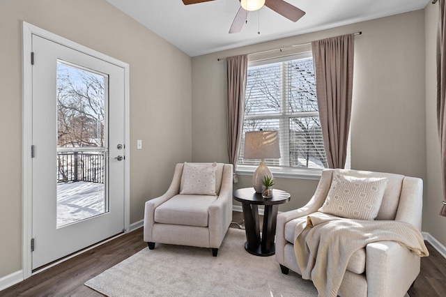 sitting room with ceiling fan, wood finished floors, and baseboards