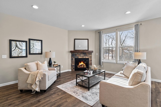 living area with dark wood-style flooring, a fireplace, and baseboards