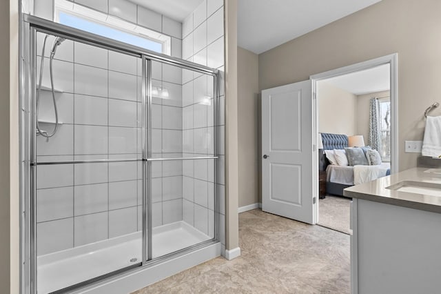 ensuite bathroom with baseboards, ensuite bath, vanity, and a shower stall