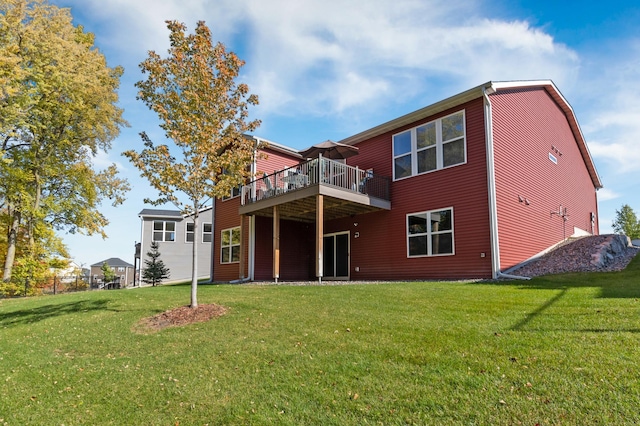 back of property featuring a deck and a lawn