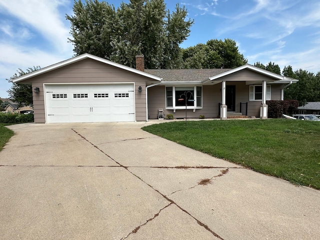 ranch-style home featuring a garage and a front lawn