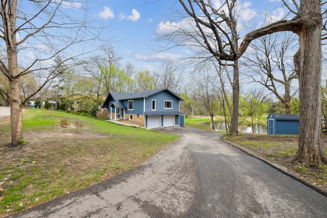 5745 Echo Rd, Excelsior, MN 55331 - view of front of house with brick siding, aphalt driveway, a front lawn, and a garage