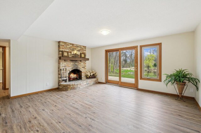 5745 Echo Rd, Excelsior, MN 55331 - unfurnished living room with baseboards, wood finished floors, and a fireplace