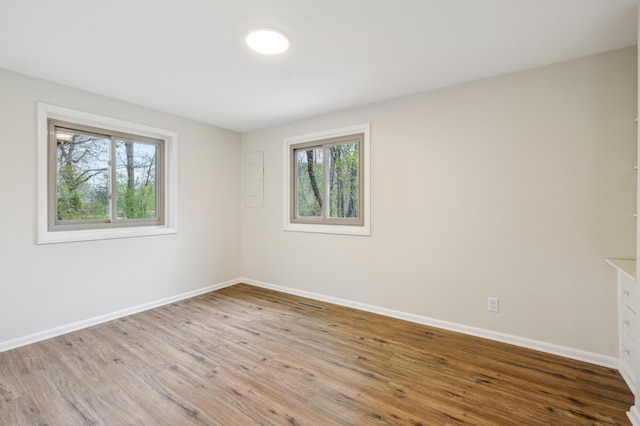 5745 Echo Rd, Excelsior, MN 55331 - spare room with baseboards, wood finished floors, and visible vents