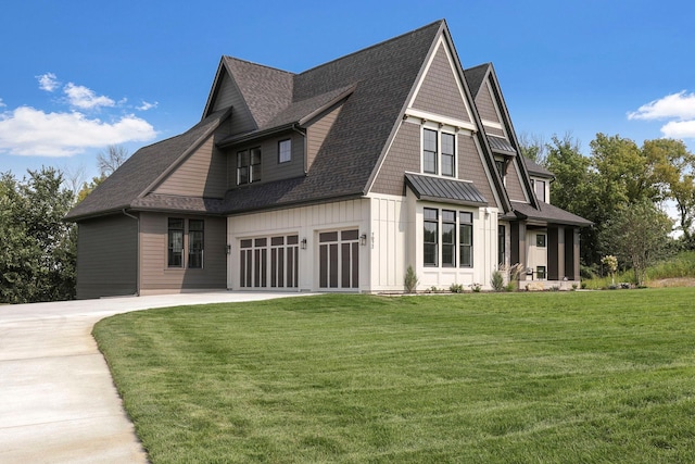 view of side of property featuring board and batten siding, concrete driveway, a yard, and a shingled roof