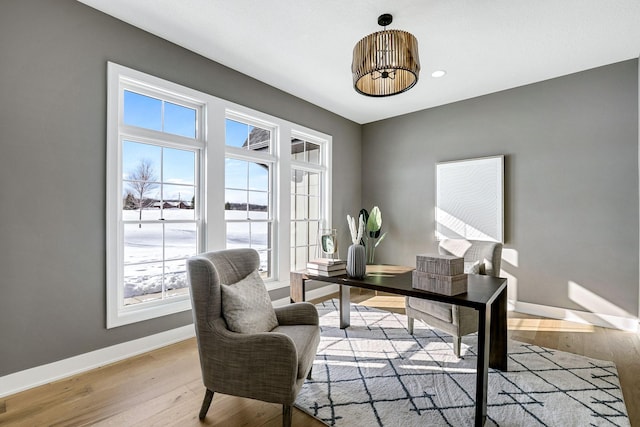 office area featuring light wood-type flooring and baseboards