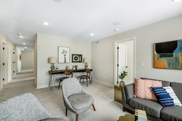 living room featuring light colored carpet, visible vents, baseboards, and recessed lighting