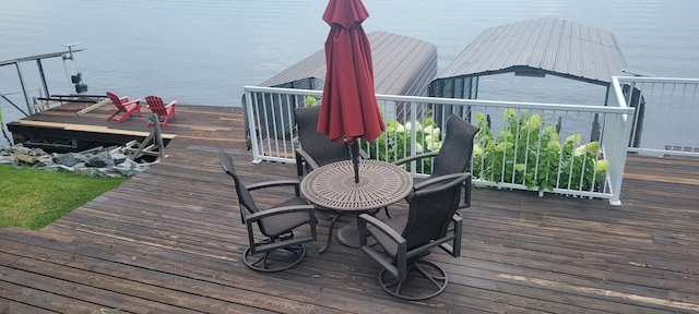 wooden deck featuring a water view and a boat dock