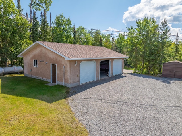 garage featuring a lawn