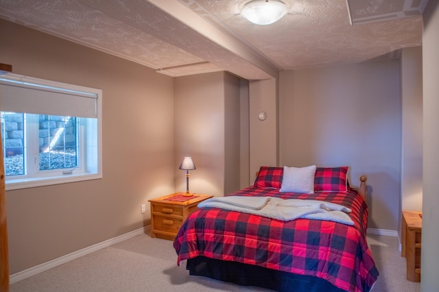 bedroom with a textured ceiling and carpet flooring