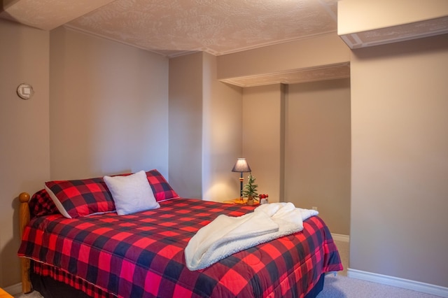 carpeted bedroom featuring a textured ceiling