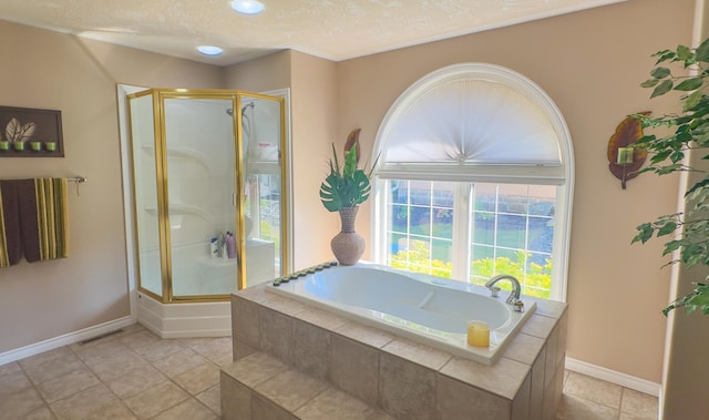 bathroom featuring a textured ceiling, shower with separate bathtub, and tile patterned flooring