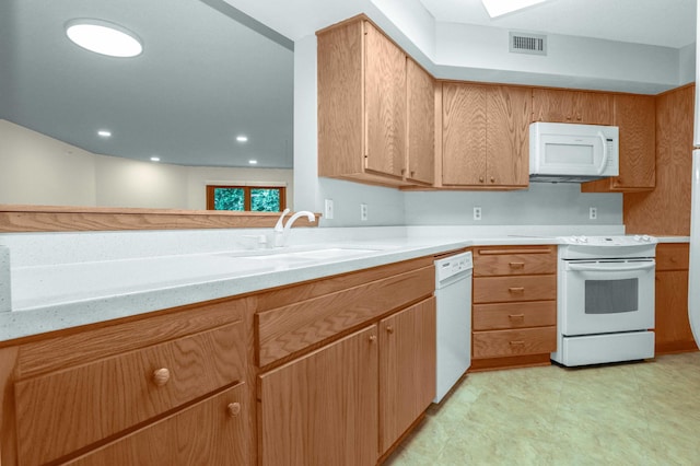 kitchen with light tile patterned floors, sink, and white appliances