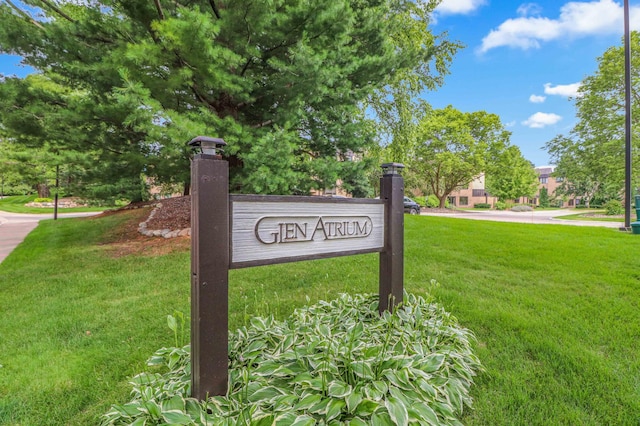 community sign featuring a lawn