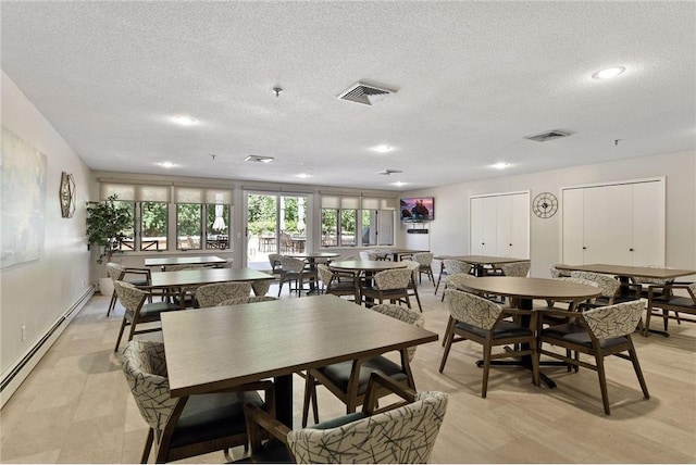 dining room with a textured ceiling and baseboard heating