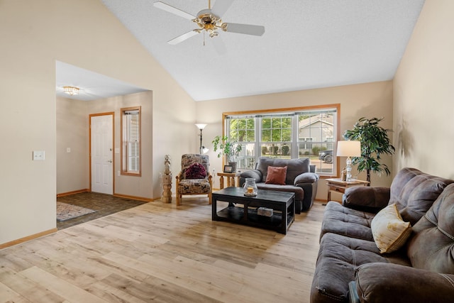 living room featuring a textured ceiling, ceiling fan, light hardwood / wood-style flooring, and high vaulted ceiling