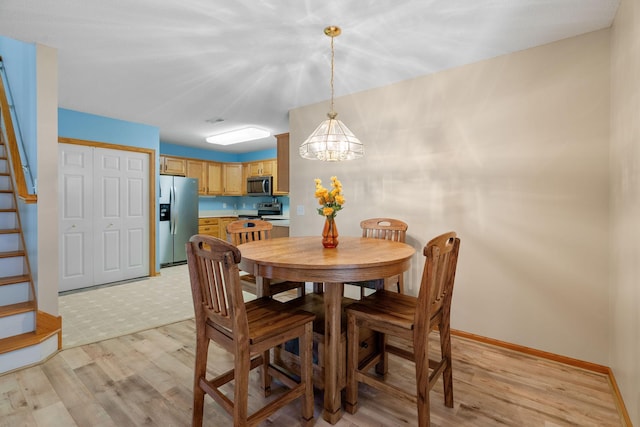 dining room featuring a chandelier and light hardwood / wood-style flooring