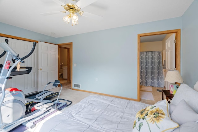 bedroom featuring light carpet, a closet, ceiling fan, and ensuite bathroom