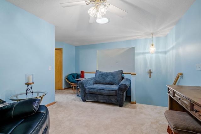 living area with ceiling fan and light colored carpet