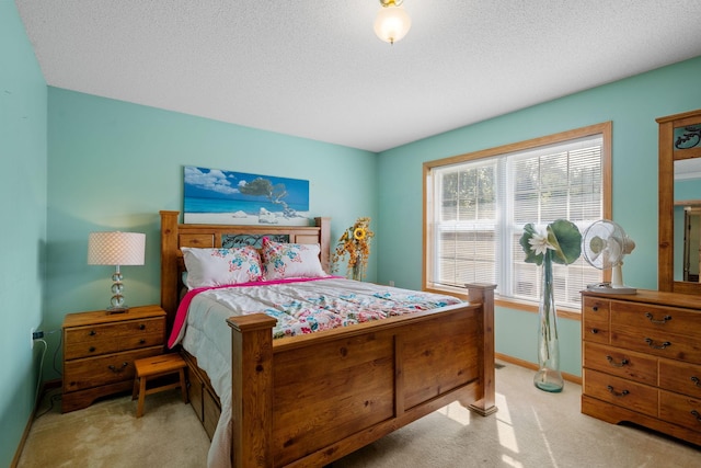 bedroom featuring a textured ceiling and light carpet