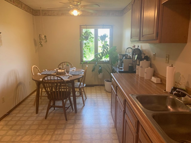 kitchen with ceiling fan, light tile patterned floors, and sink