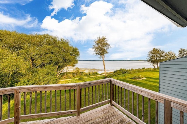 deck with a yard and a water view