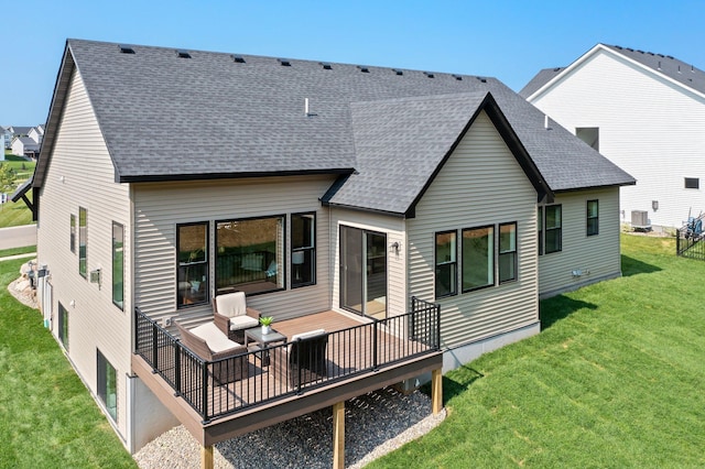 rear view of property featuring cooling unit and a lawn