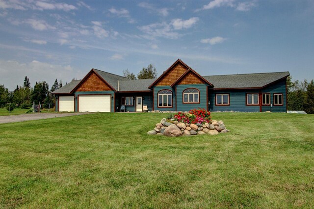 view of front of house with a garage and a front yard