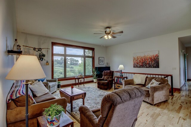 living room featuring light wood-type flooring and ceiling fan