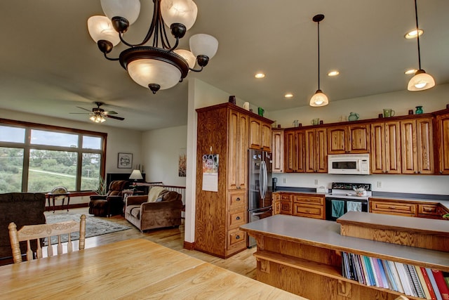 kitchen featuring white microwave, open floor plan, light wood-type flooring, freestanding refrigerator, and electric range oven