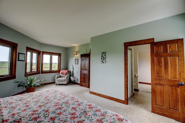 bedroom featuring baseboards and light colored carpet