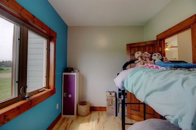 bedroom featuring baseboards and light wood-style floors