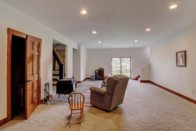 living room featuring a wood stove, light colored carpet, and recessed lighting