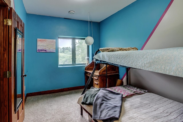 bedroom featuring baseboards and light colored carpet