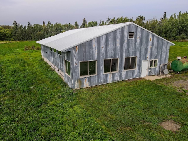 back of property with a garage and a yard