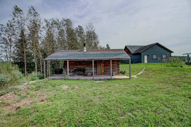 rear view of house with a lawn and a patio