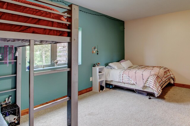 bedroom with carpet and baseboards