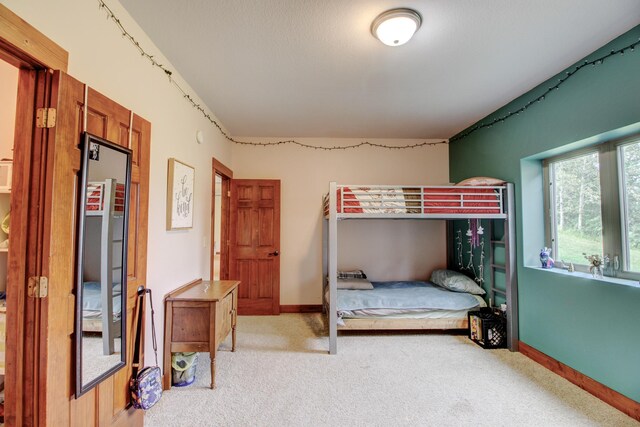 carpeted bedroom with baseboards