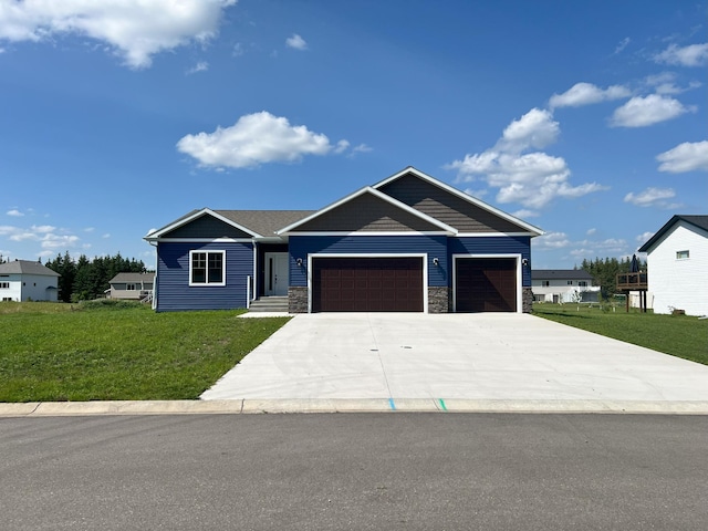 view of front of property featuring a front lawn and a garage