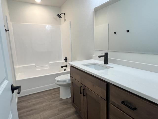 full bathroom featuring toilet, hardwood / wood-style flooring, vanity, and tub / shower combination