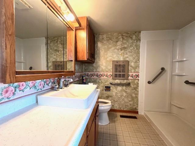 bathroom with tile patterned flooring, toilet, and vanity